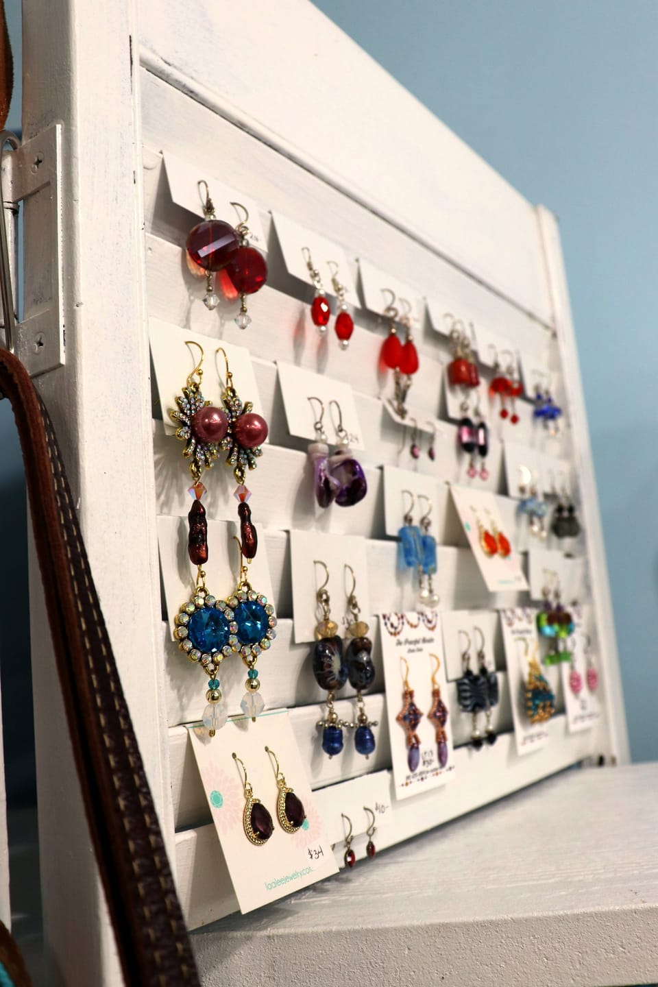 Handmade beaded earrings on a display board